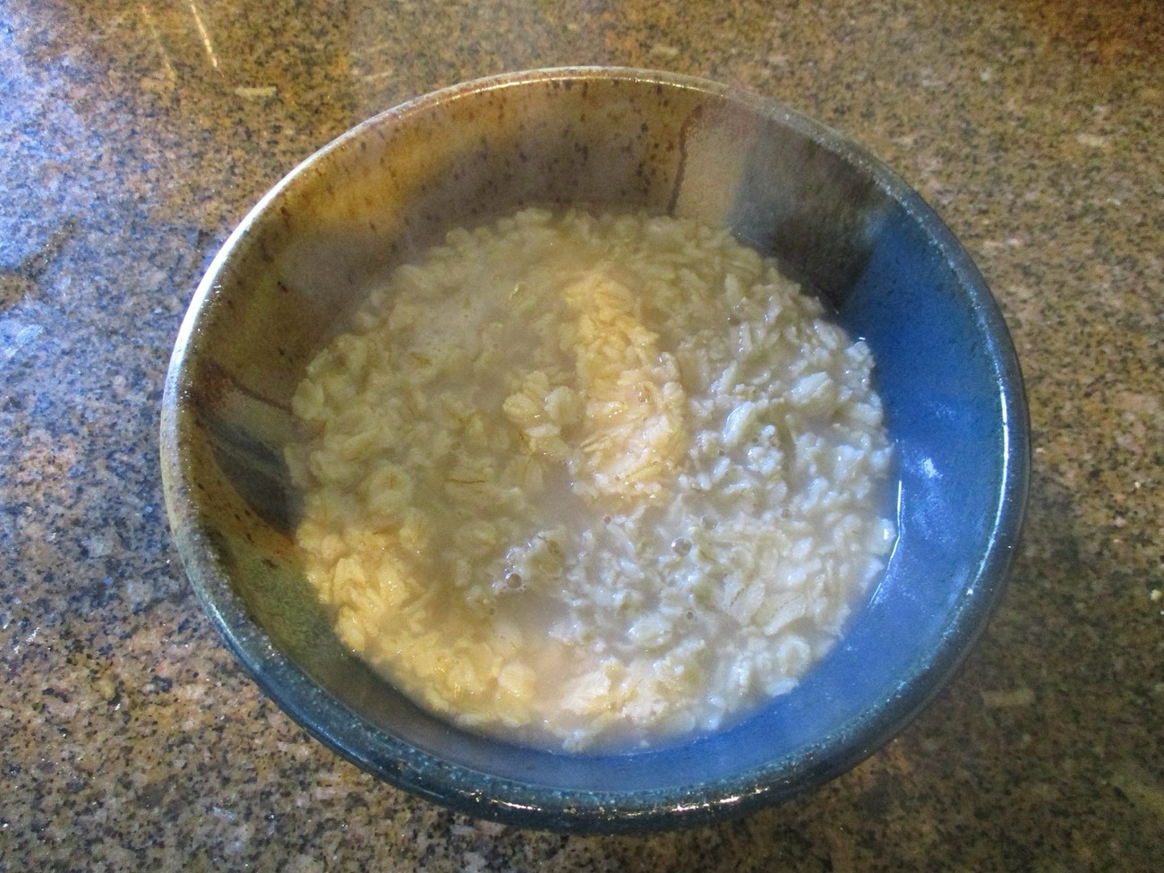 A warm bowl of cooked oatmeal porridge — a soft, protein-friendly breakfast during recovery